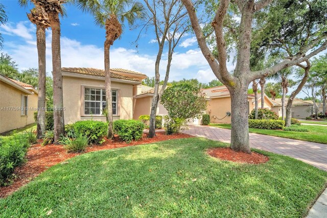 6843 Montrose Way, Boynton Beach, FL 33437 - mediterranean / spanish home with stucco siding, a tiled roof, decorative driveway, and a front yard