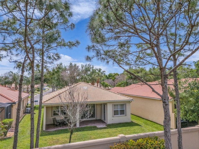 6843 Montrose Way, Boynton Beach, FL 33437 - rear view of house featuring a tiled roof, stucco siding, a lawn, and a patio