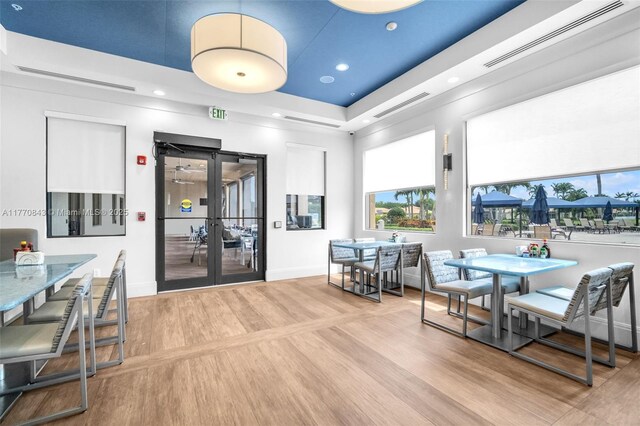 6843 Montrose Way, Boynton Beach, FL 33437 - dining room featuring french doors, baseboards, recessed lighting, a raised ceiling, and wood finished floors