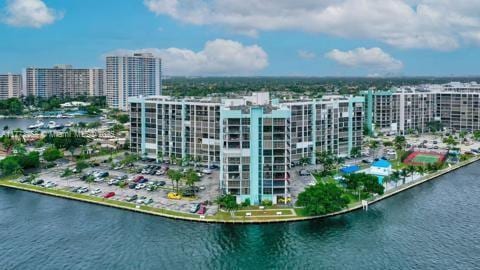 birds eye view of property with a city view and a water view