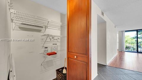 corridor with tile patterned flooring and visible vents