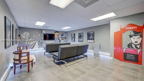 living room with a paneled ceiling