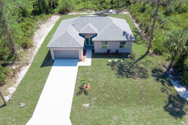 view of front of home featuring an attached garage, stucco siding, concrete driveway, and a front yard