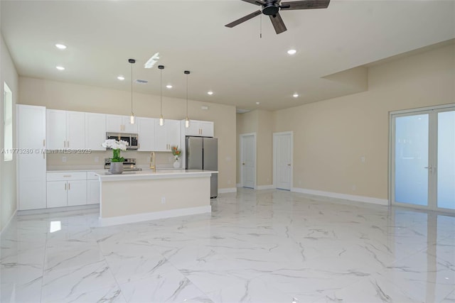 kitchen with stainless steel appliances, open floor plan, a sink, a center island with sink, and recessed lighting