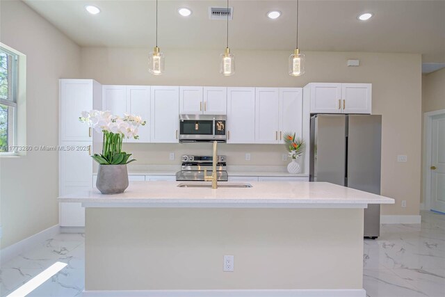 kitchen featuring appliances with stainless steel finishes, light marble finish floors, white cabinetry, baseboards, and recessed lighting