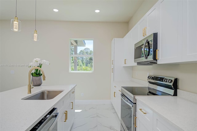 kitchen with stainless steel appliances, a sink, light countertops, white cabinetry, and recessed lighting
