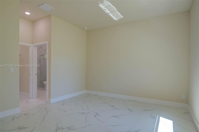 spare room featuring marble finish flooring, recessed lighting, and baseboards