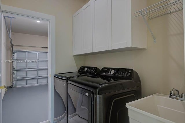washroom with washer and dryer, cabinet space, and recessed lighting