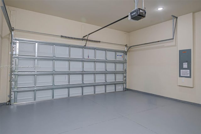 garage with a garage door opener, electric panel, and recessed lighting