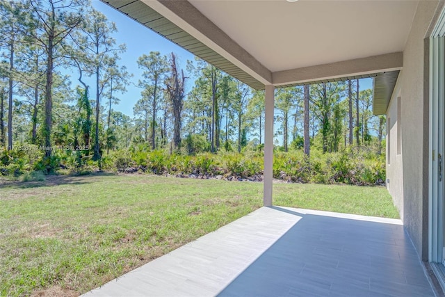 view of grassy yard with a patio