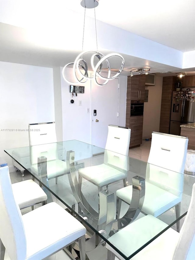 427 Golden Isles Dr Unit 5G, Hallandale Beach, FL 33009 - dining space featuring an inviting chandelier