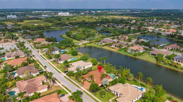 bird's eye view featuring a residential view and a water view