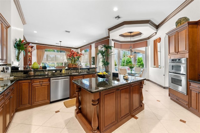 kitchen with a sink, a kitchen island, light tile patterned floors, stainless steel appliances, and ornamental molding