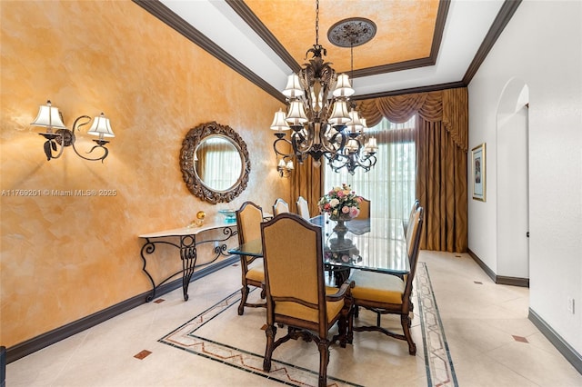 dining room featuring a tray ceiling, a chandelier, baseboards, arched walkways, and ornamental molding