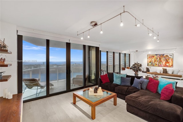 20281 E Country Club Dr Unit 1002, Aventura, FL 33180 - living room featuring rail lighting, a water view, wood finished floors, floor to ceiling windows, and healthy amount of natural light