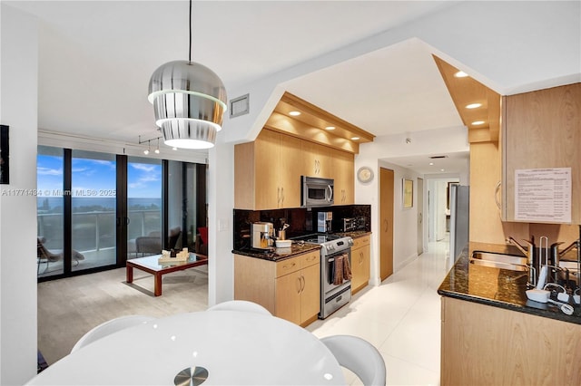 20281 E Country Club Dr Unit 1002, Aventura, FL 33180 - kitchen featuring stainless steel appliances, light brown cabinetry, dark stone countertops, recessed lighting, and tasteful backsplash