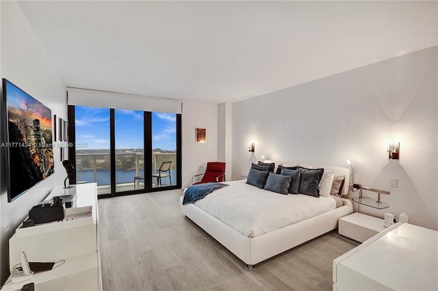 20281 E Country Club Dr Unit 1002, Aventura, FL 33180 - bedroom featuring expansive windows, light wood finished floors, a water view, and access to exterior