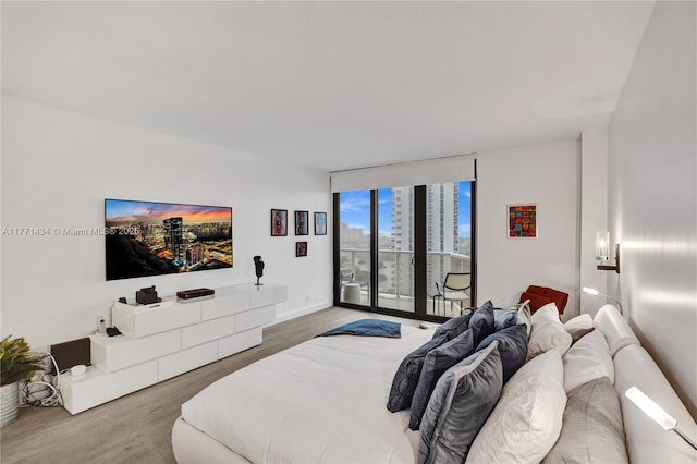 20281 E Country Club Dr Unit 1002, Aventura, FL 33180 - bedroom with access to exterior and wood finished floors
