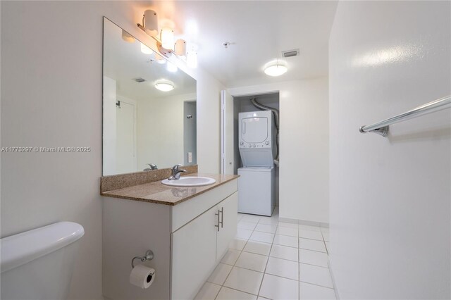 1861 NW S River Dr Unit 1904, Miami, FL 33125 - bathroom with toilet, vanity, stacked washing maching and dryer, and visible vents