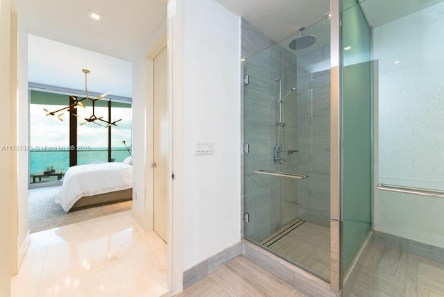16901 Collins Ave Unit 1404, Sunny Isles Beach, FL 33160 - bathroom featuring a shower stall, a chandelier, ensuite bath, and tile patterned floors