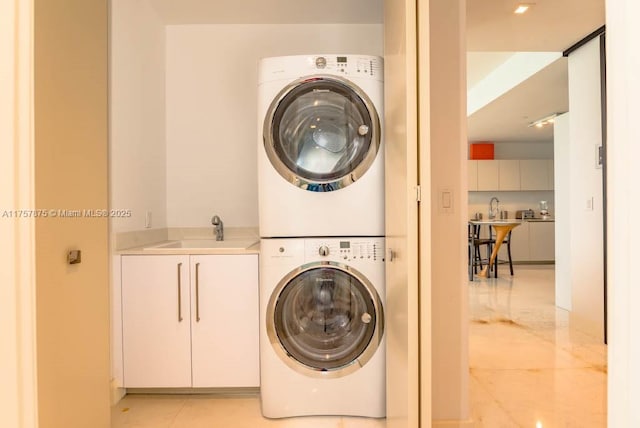 16901 Collins Ave Unit 1404, Sunny Isles Beach, FL 33160 - laundry room featuring stacked washer / drying machine and cabinet space