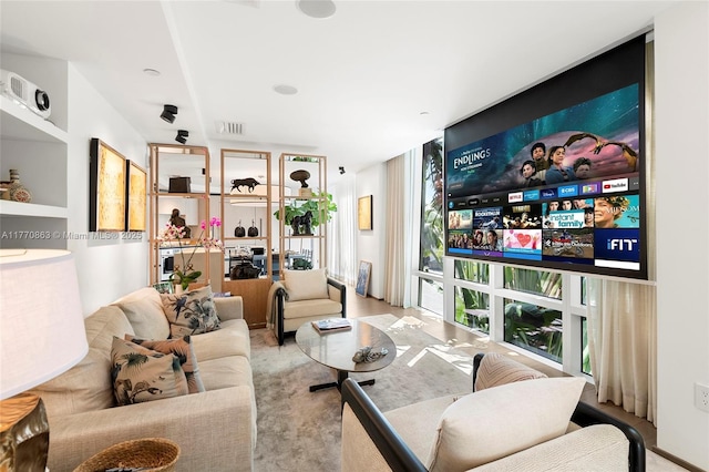 living room with visible vents and a wall of windows