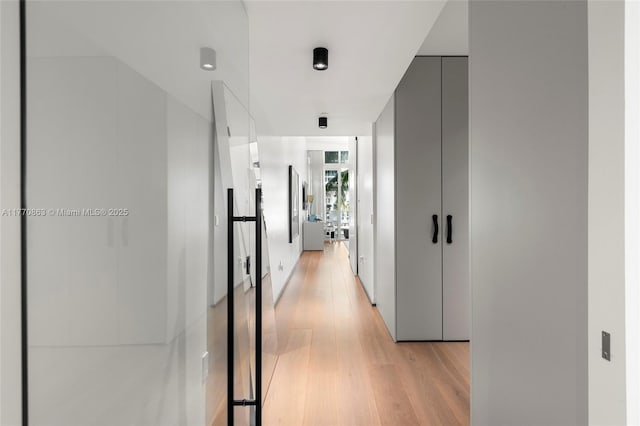 hallway with light wood-type flooring