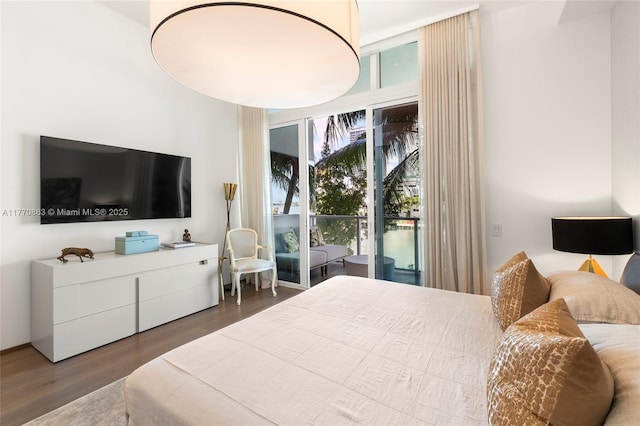 bedroom with access to exterior and wood finished floors