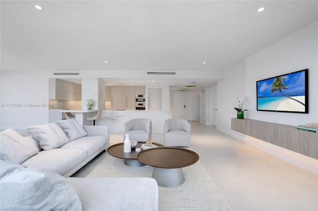 3201 S Ocean Blvd Unit 704, Highland Beach, FL 33487 - living room featuring concrete flooring and recessed lighting