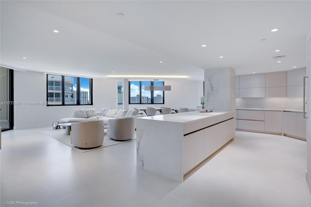 3201 S Ocean Blvd Unit 704, Highland Beach, FL 33487 - kitchen featuring modern cabinets, recessed lighting, white cabinets, light countertops, and open floor plan