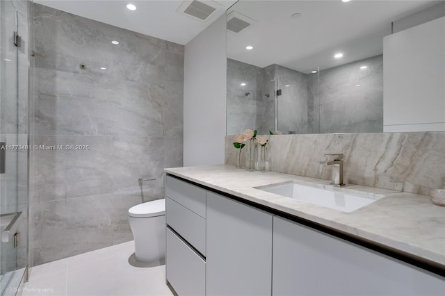3201 S Ocean Blvd Unit 704, Highland Beach, FL 33487 - bathroom with vanity, toilet, tile walls, a shower with door, and recessed lighting