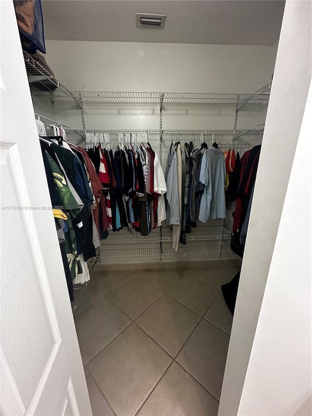 walk in closet featuring visible vents and tile patterned flooring