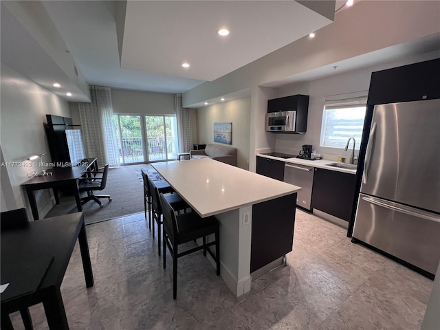 5300 NW 87th Ave Unit 916, Doral, FL 33178 - kitchen with a sink, a kitchen island, dark cabinetry, and stainless steel appliances