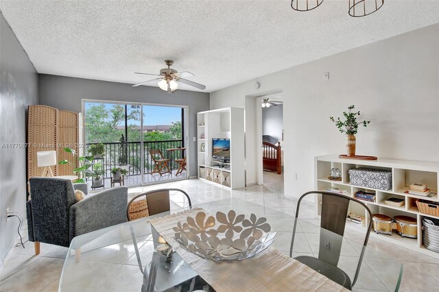 13701 SW 12th St Unit 310A, Pembroke Pines, FL 33027 - dining space with a ceiling fan, a textured ceiling, and light tile patterned flooring