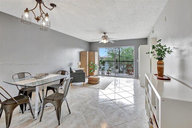 13701 SW 12th St Unit 310A, Pembroke Pines, FL 33027 - dining area featuring a textured ceiling, a ceiling fan, and light tile patterned floors