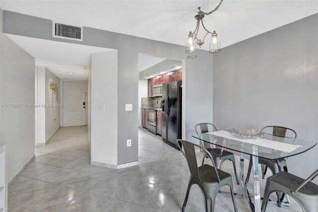 13701 SW 12th St Unit 310A, Pembroke Pines, FL 33027 - dining room with baseboards and light tile patterned floors
