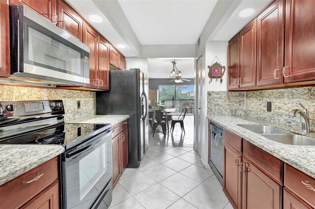 13701 SW 12th St Unit 310A, Pembroke Pines, FL 33027 - kitchen featuring black appliances, a sink, light tile patterned floors, backsplash, and light stone countertops