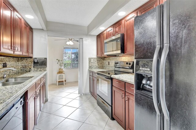 13701 SW 12th St Unit 310A, Pembroke Pines, FL 33027 - kitchen featuring black appliances, a sink, light tile patterned floors, backsplash, and a ceiling fan