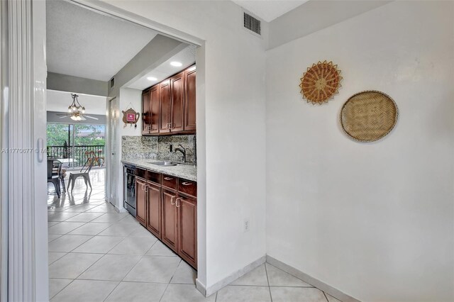 13701 SW 12th St Unit 310A, Pembroke Pines, FL 33027 - bar featuring light tile patterned floors, a sink, tasteful backsplash, ceiling fan, and baseboards