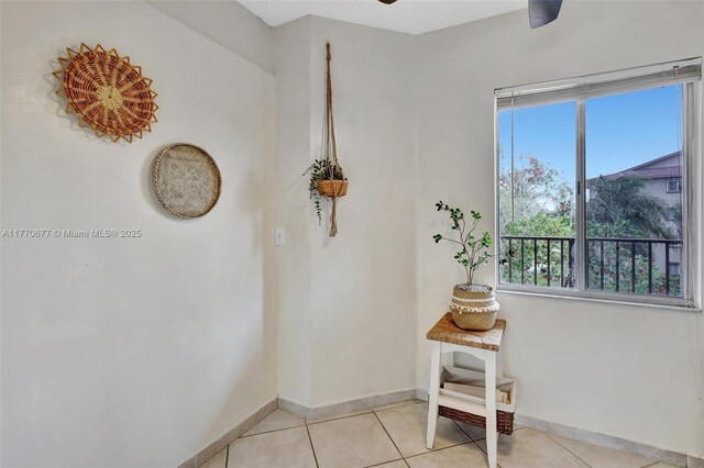 13701 SW 12th St Unit 310A, Pembroke Pines, FL 33027 - spare room featuring baseboards, healthy amount of natural light, a ceiling fan, and light tile patterned floors