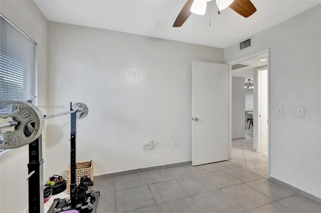 13701 SW 12th St Unit 310A, Pembroke Pines, FL 33027 - unfurnished bedroom with light tile patterned floors, a ceiling fan, and baseboards