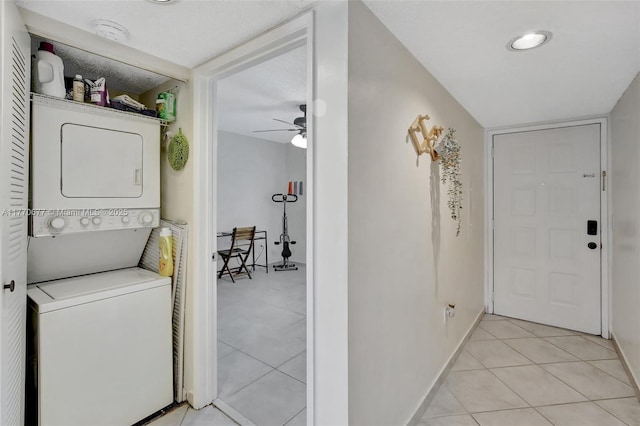 13701 SW 12th St Unit 310A, Pembroke Pines, FL 33027 - laundry room featuring stacked washing machine and dryer, ceiling fan, light tile patterned floors, and baseboards
