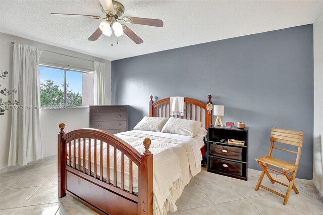 13701 SW 12th St Unit 310A, Pembroke Pines, FL 33027 - tiled bedroom featuring ceiling fan and a textured ceiling