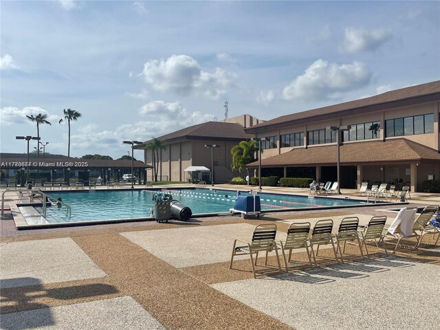 13701 SW 12th St Unit 310A, Pembroke Pines, FL 33027 - community pool featuring a patio area