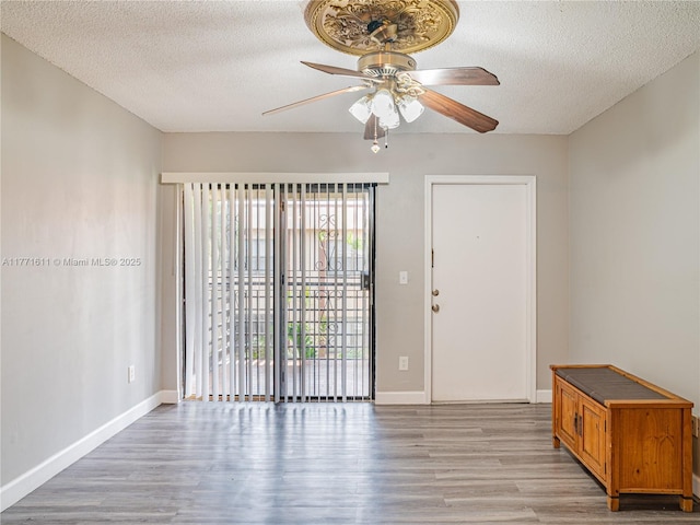 6545 W 27th Ct Unit 24-47, Hialeah, FL 33016 - unfurnished room featuring light wood-style floors, ceiling fan, and a textured ceiling