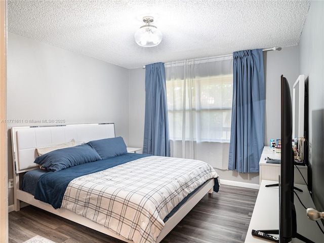 6545 W 27th Ct Unit 24-47, Hialeah, FL 33016 - bedroom with dark wood-style floors and a textured ceiling