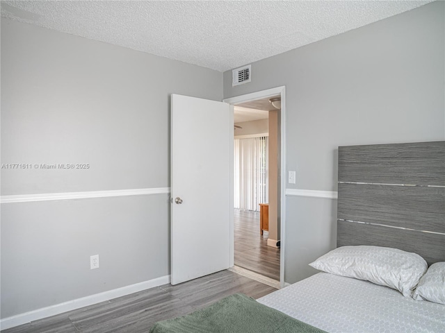 6545 W 27th Ct Unit 24-47, Hialeah, FL 33016 - bedroom with wood finished floors and a textured ceiling