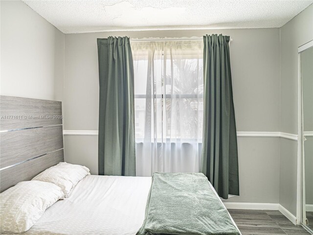 6545 W 27th Ct Unit 24-47, Hialeah, FL 33016 - bedroom with wood finished floors and a textured ceiling