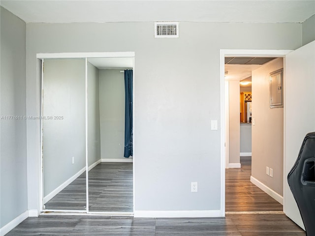 6545 W 27th Ct Unit 24-47, Hialeah, FL 33016 - unfurnished bedroom with wood finished floors and a closet