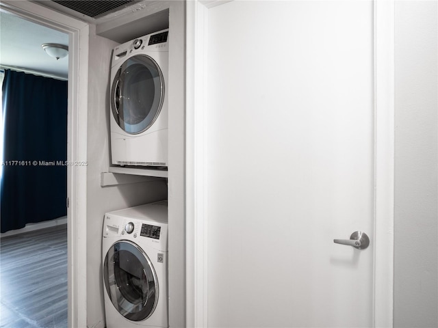 6545 W 27th Ct Unit 24-47, Hialeah, FL 33016 - laundry room featuring estacked washer and dryer and wood finished floors